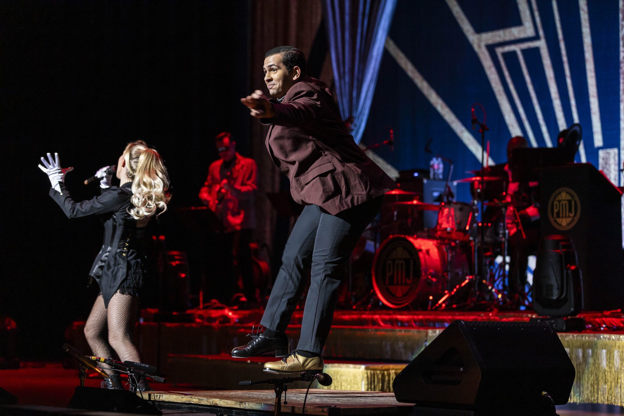 a man leaps on stage while dancing