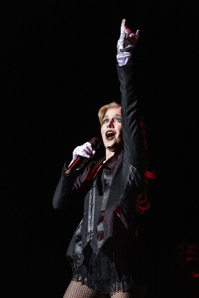 A woman sings her final notes on stage